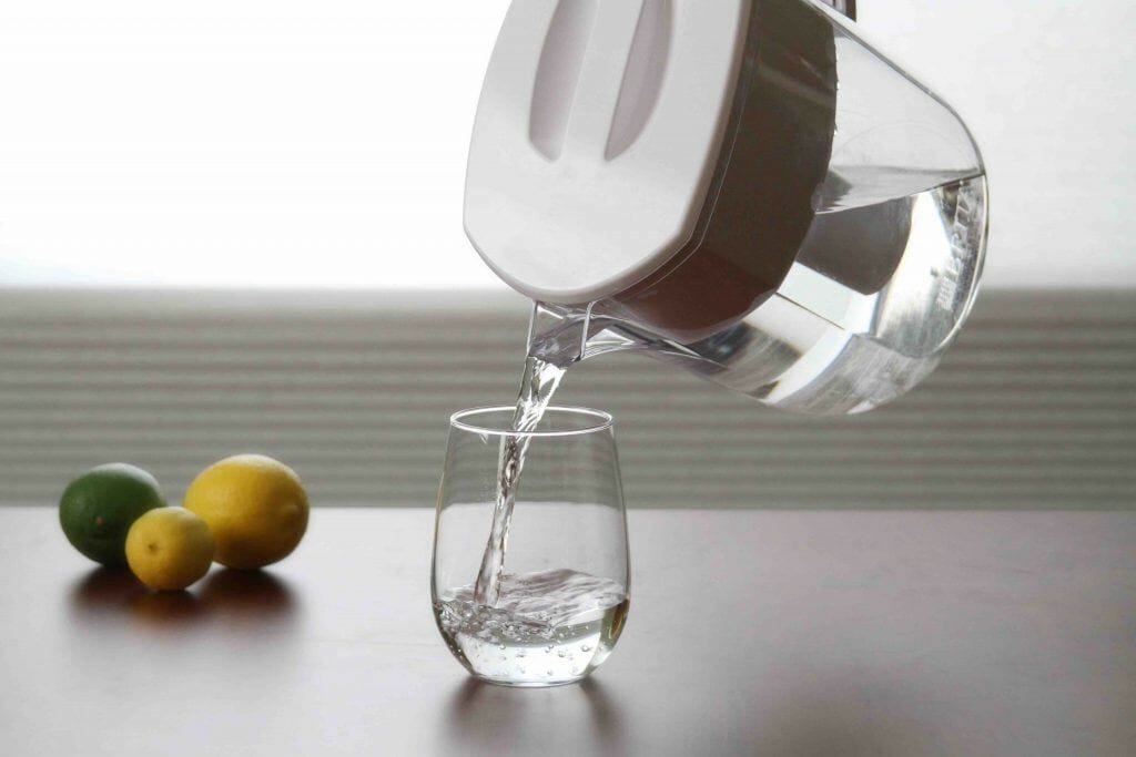 pouring filtered water into the glass