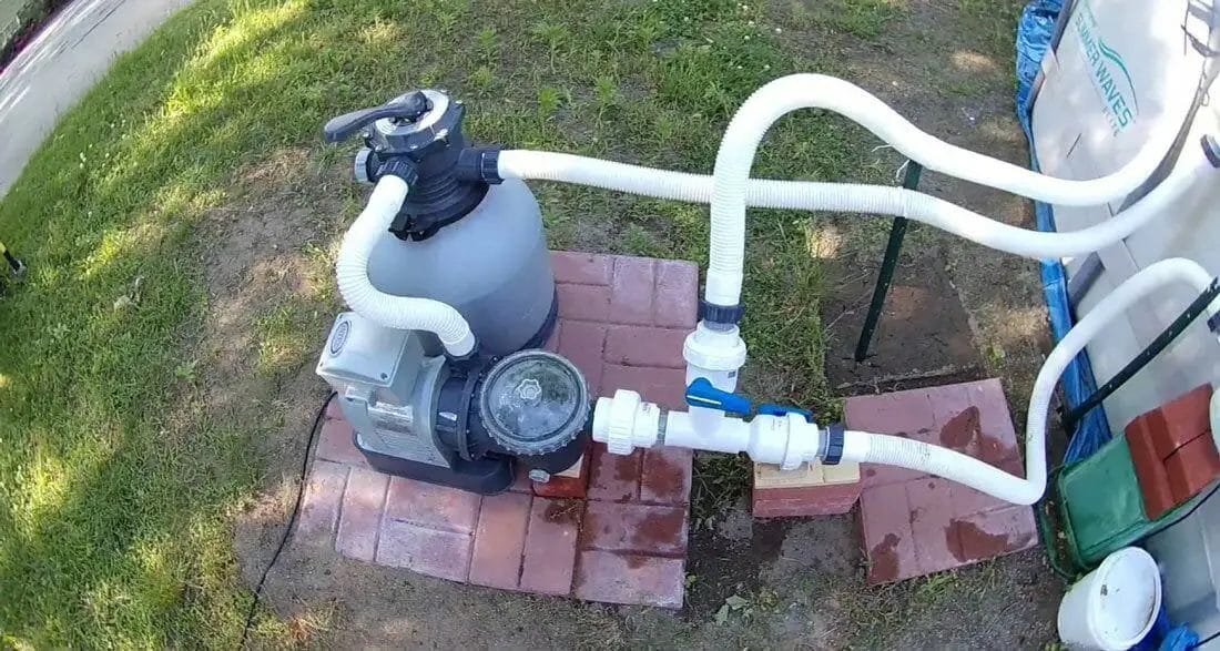 vacuuming above ground pool with sand filter
